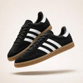 Black suede low-profile terrace trainers with white side stripes and gum sole